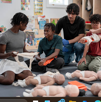 Kids and instructor practicing CPR and first aid on training mannequins